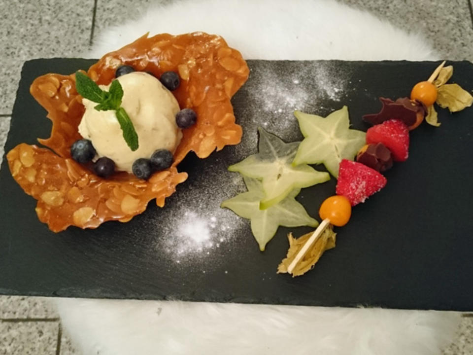 Macadamia-Eis im Karamellkörbchen mit Karambole-Carpaccio und Physalisspieß