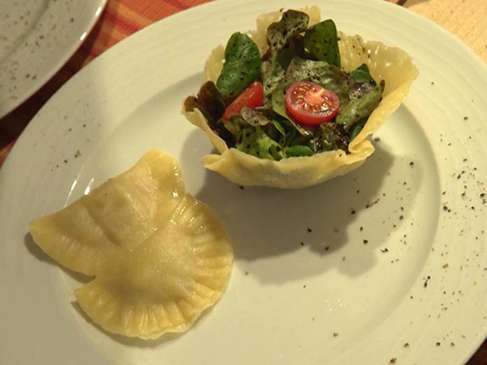 Zweierlei Mezzelune an Nussbutter und Salat im Körbchen