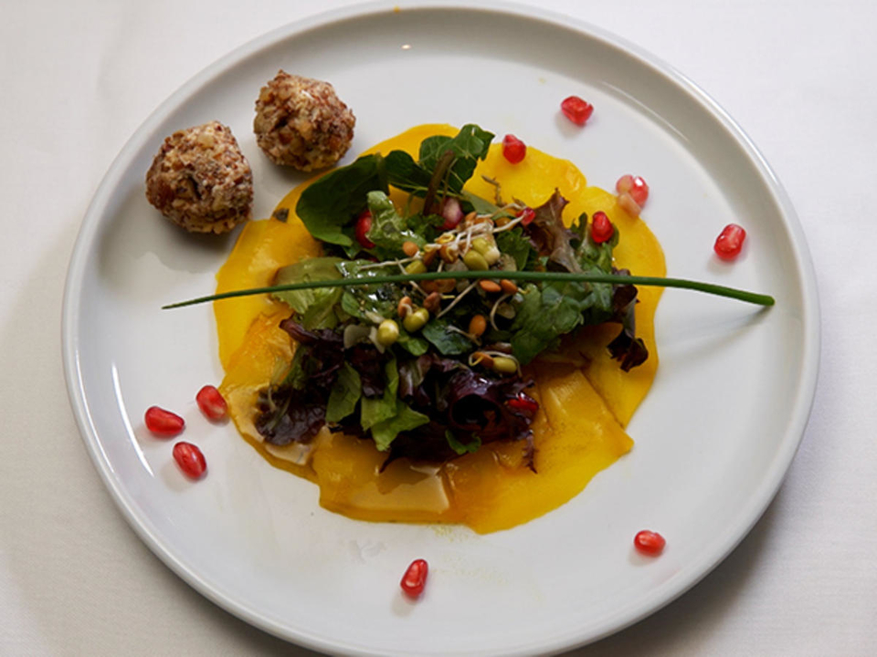Kunterbunter Salat auf gelber Bete, mit Zuckerrübenbrot und Fetabällchen