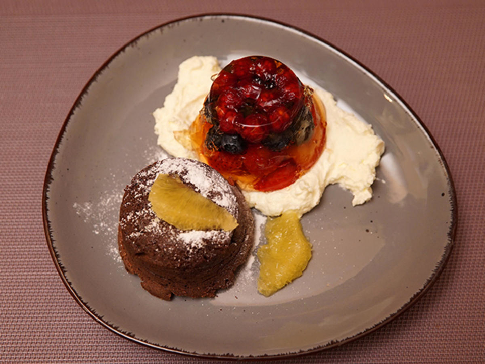 Schokoküchlein mit flüssigem Kern und Beerensülze auf Sahne-Quarknest